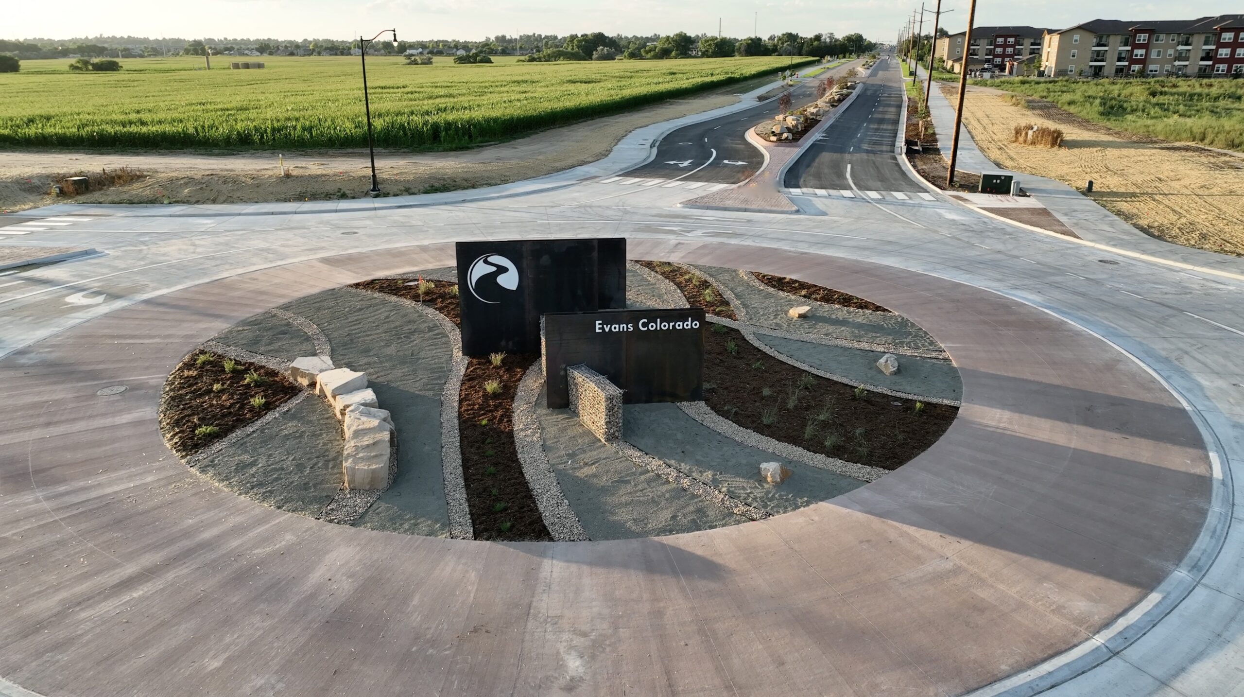 Roundabout with landscaped center and Evans Colorado sign Roundabout with landscaped center and Evans Colorado sign